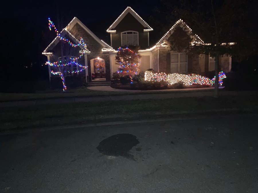 House decorated with Christmas lights at night.
