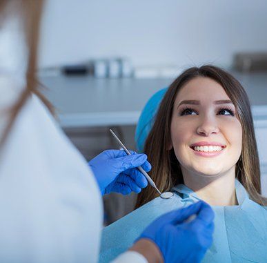 Dental Treatment —  Woman Smiling at the Dentist in Redding, CA