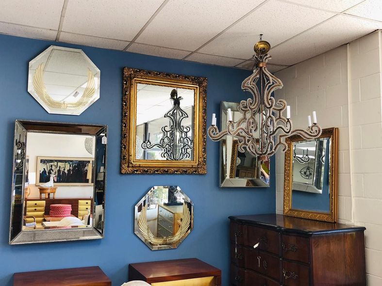 A room with lots of mirrors and a chandelier hanging from the ceiling