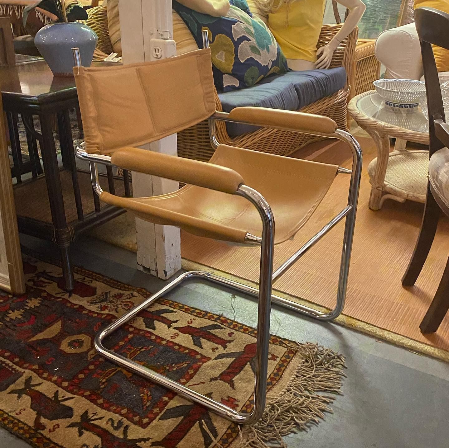A tan leather chair is sitting on a rug in a living room