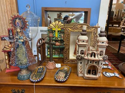 A table with a lot of religious objects on it.
