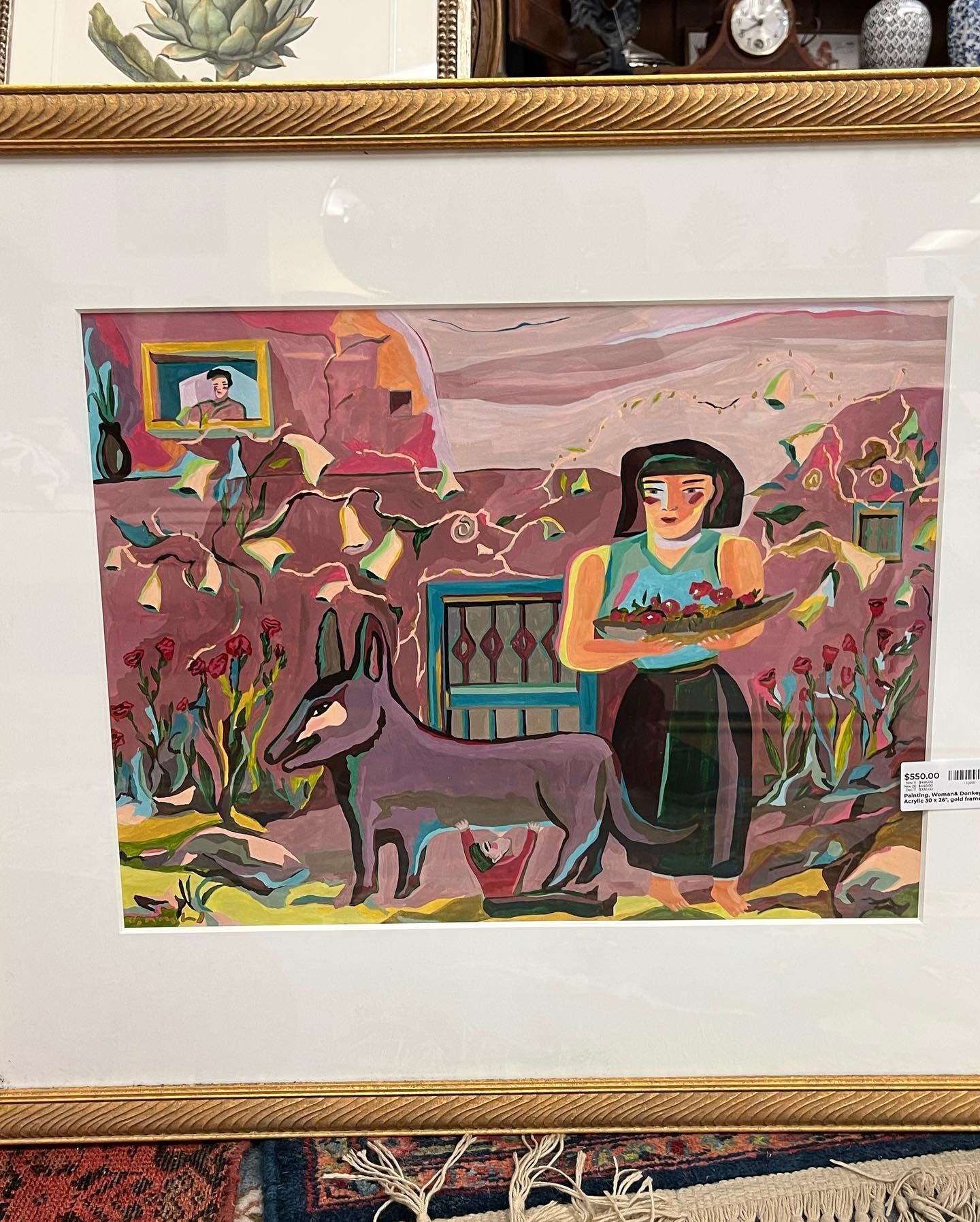 A painting of a woman standing next to a donkey in a frame.