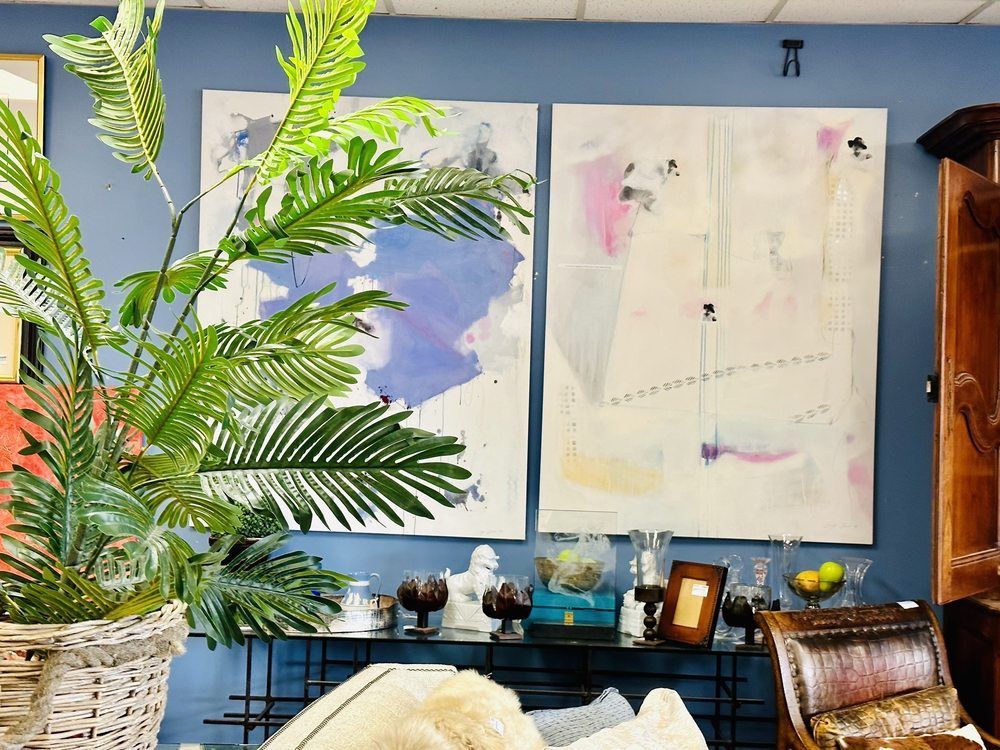 A living room with two large paintings on the wall