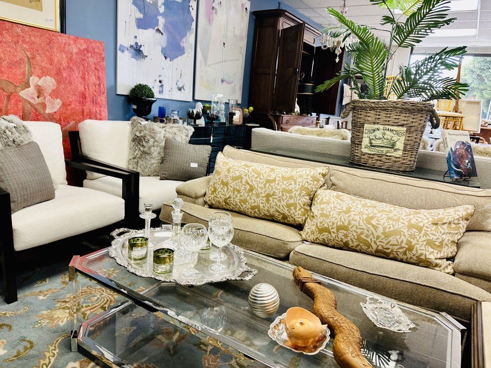 A living room filled with furniture and a glass coffee table.