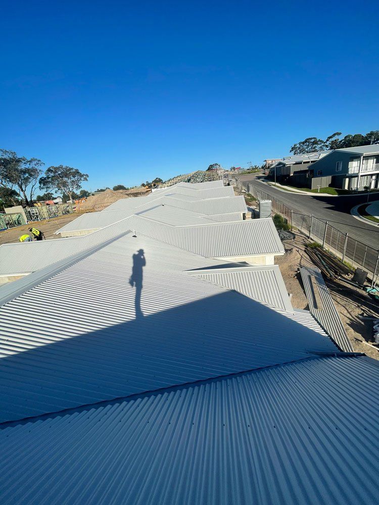 Houses With White Metal Roofing — Roofing And Guttering In Newcastle, NSW