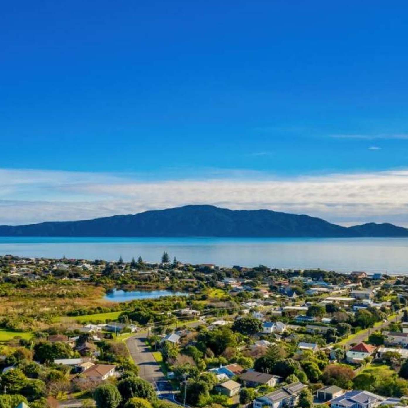 An aerial view of a residential area with mountains in the background