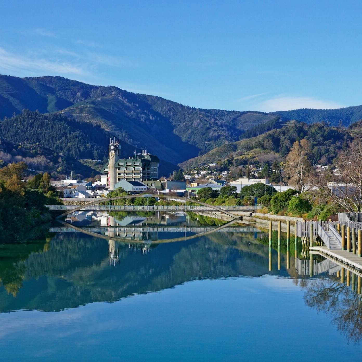 A bridge over a river with mountains in the background