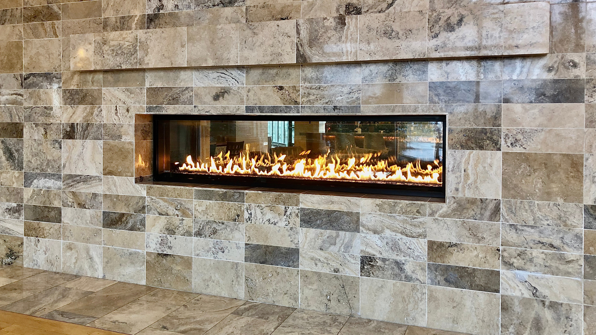 A fireplace with a brick wall surrounding it