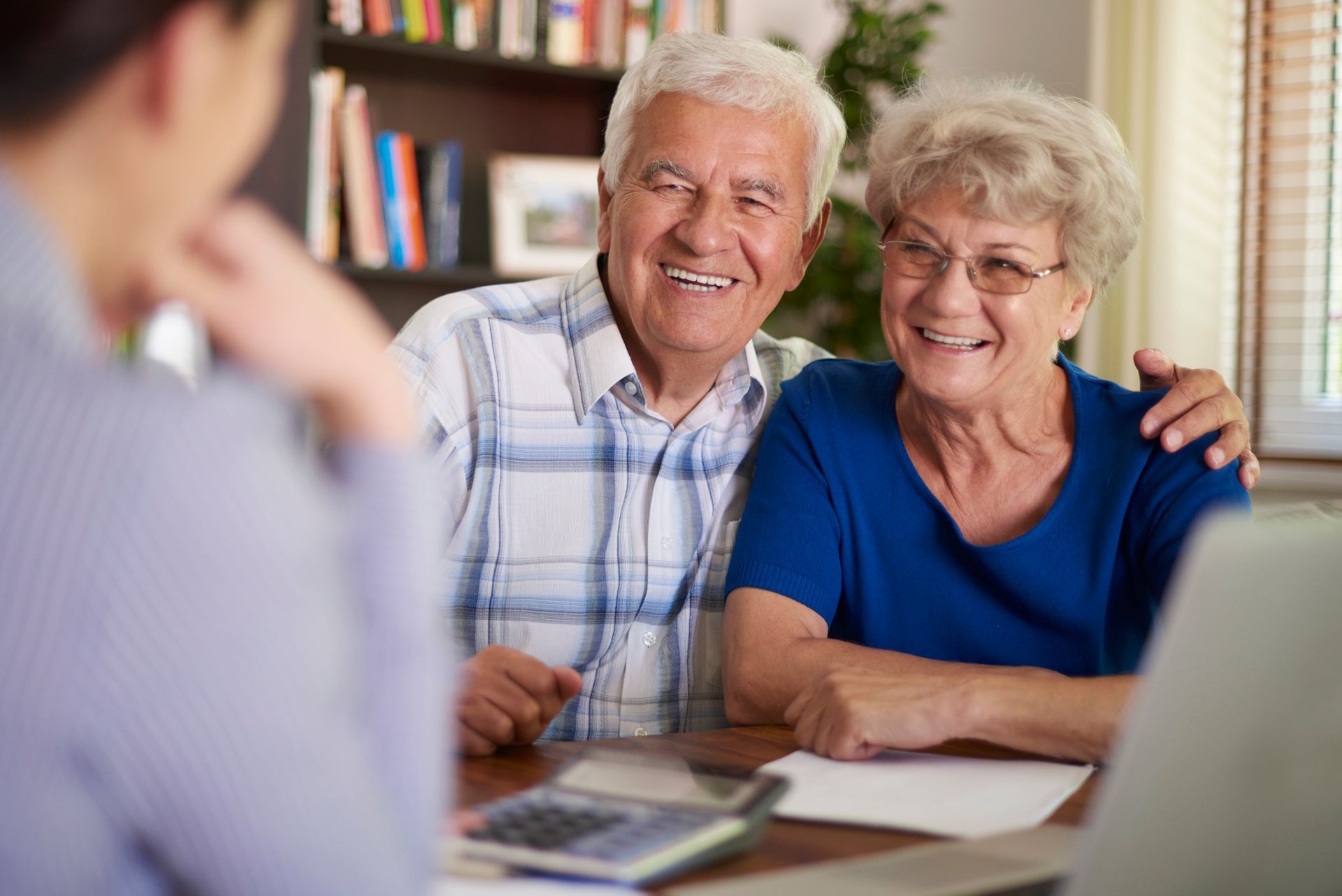 A man , a woman and a nurse are standing next to a dog Encouraging Mobility Solutions