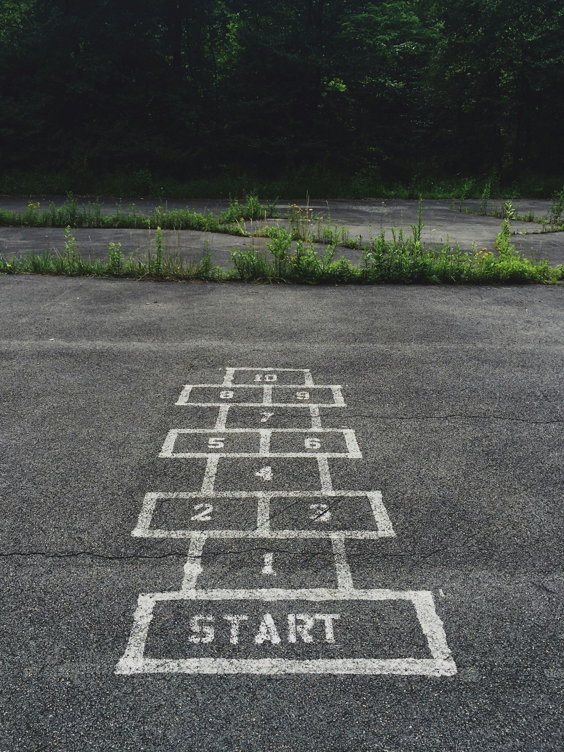 A hopscotch game on the ground with the word start at the beginning