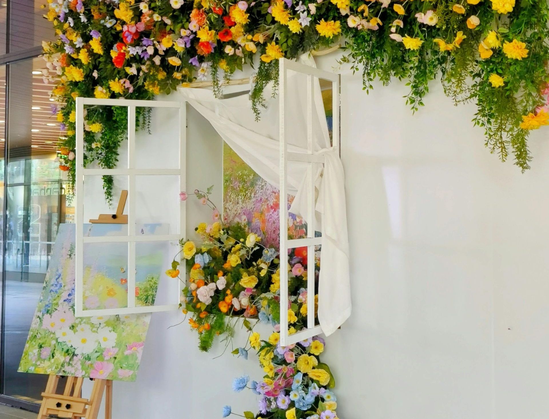 flowers flowing out of a window