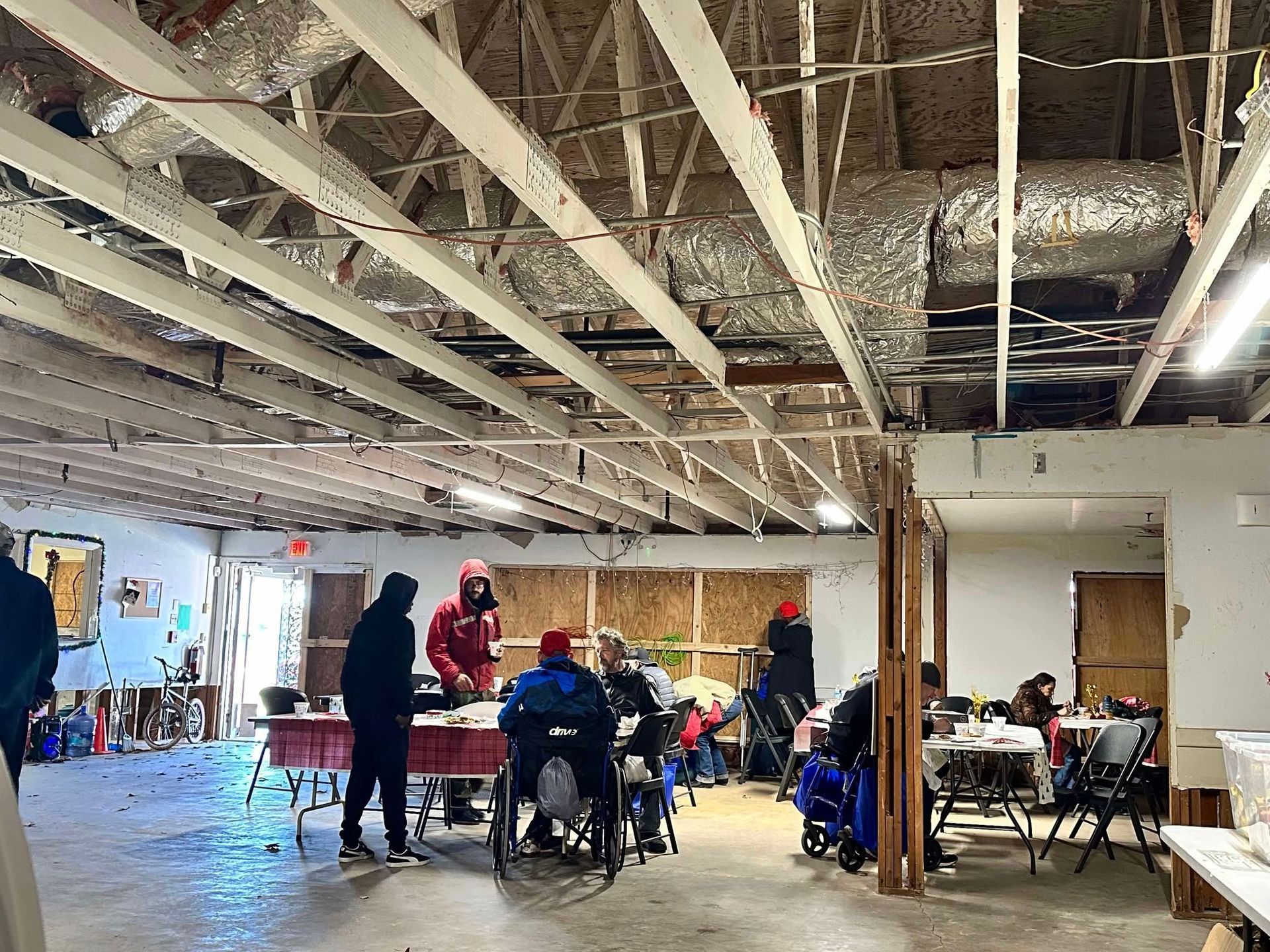 A group of people are sitting at tables in a large room.