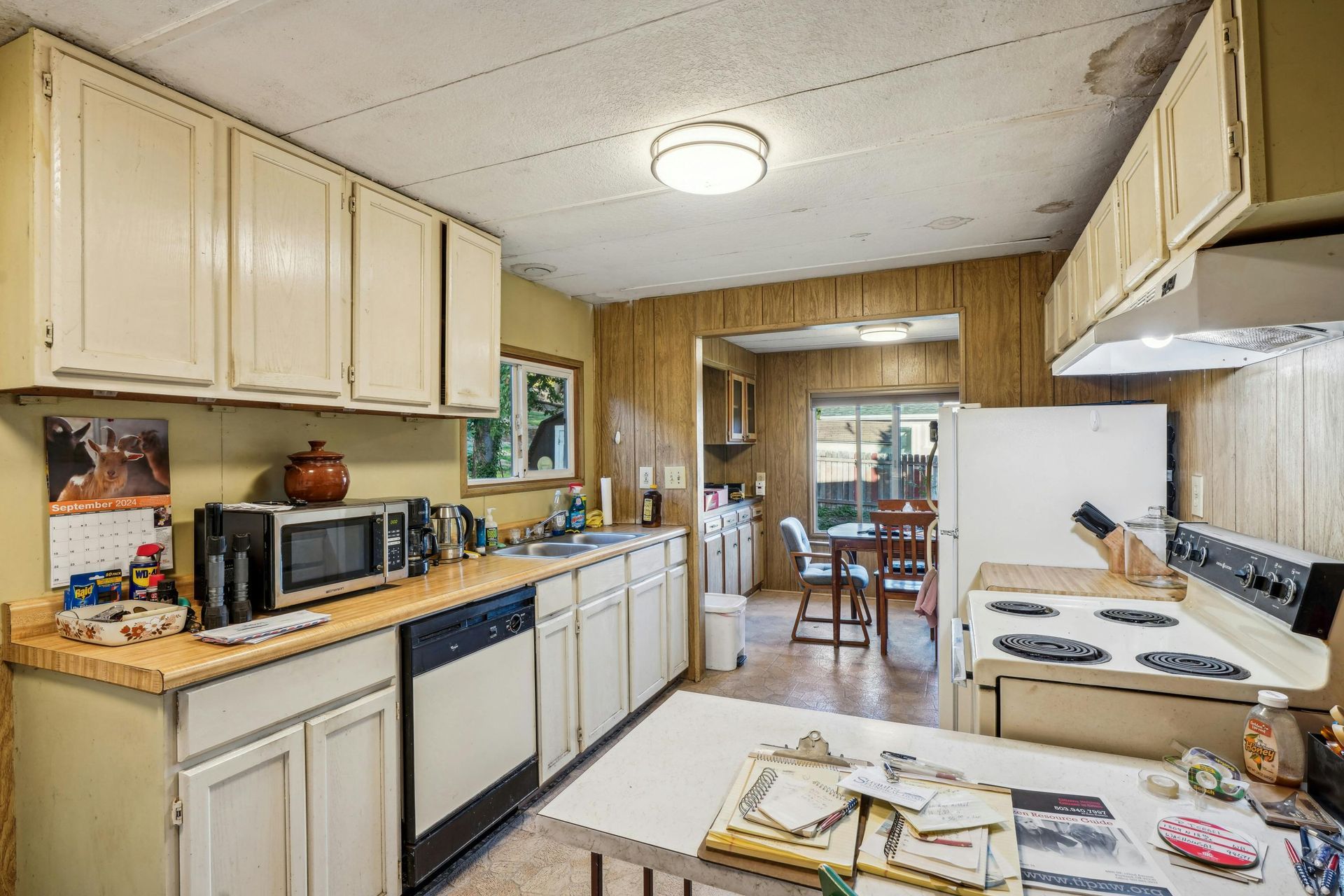 Before and after kitchen cabinet refinishing by Green Valley Painters showing updated paint and restored surfaces.