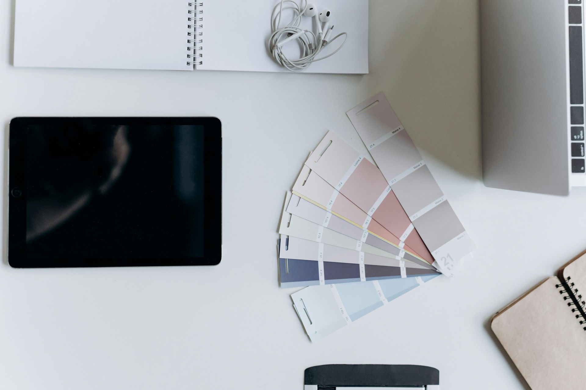 Color swatches on countertop with iPad and notebook for color consultation with client of Green Valley Painters.