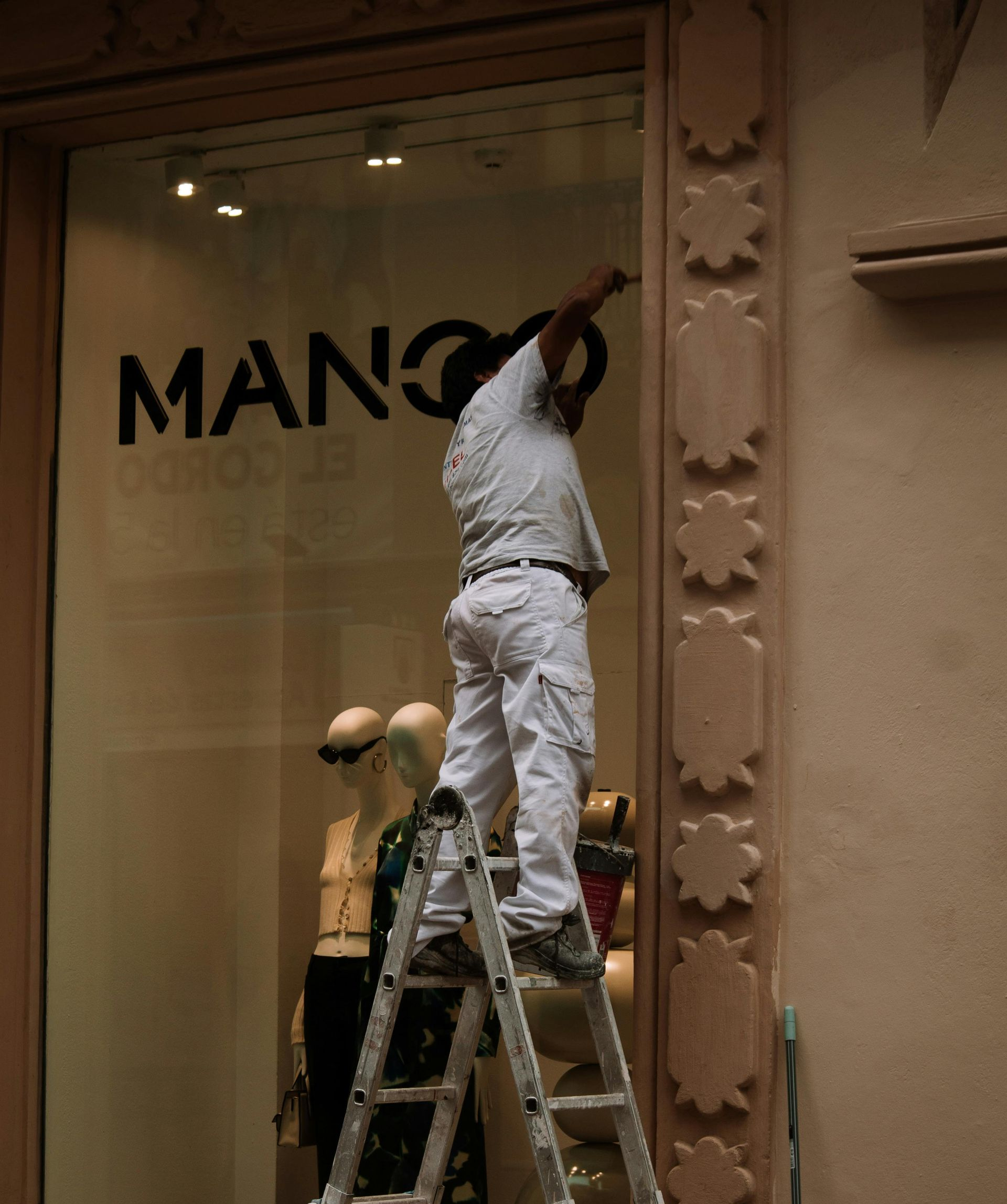 Professional painter working on exterior of a commercial building in Green Valley, AZ.