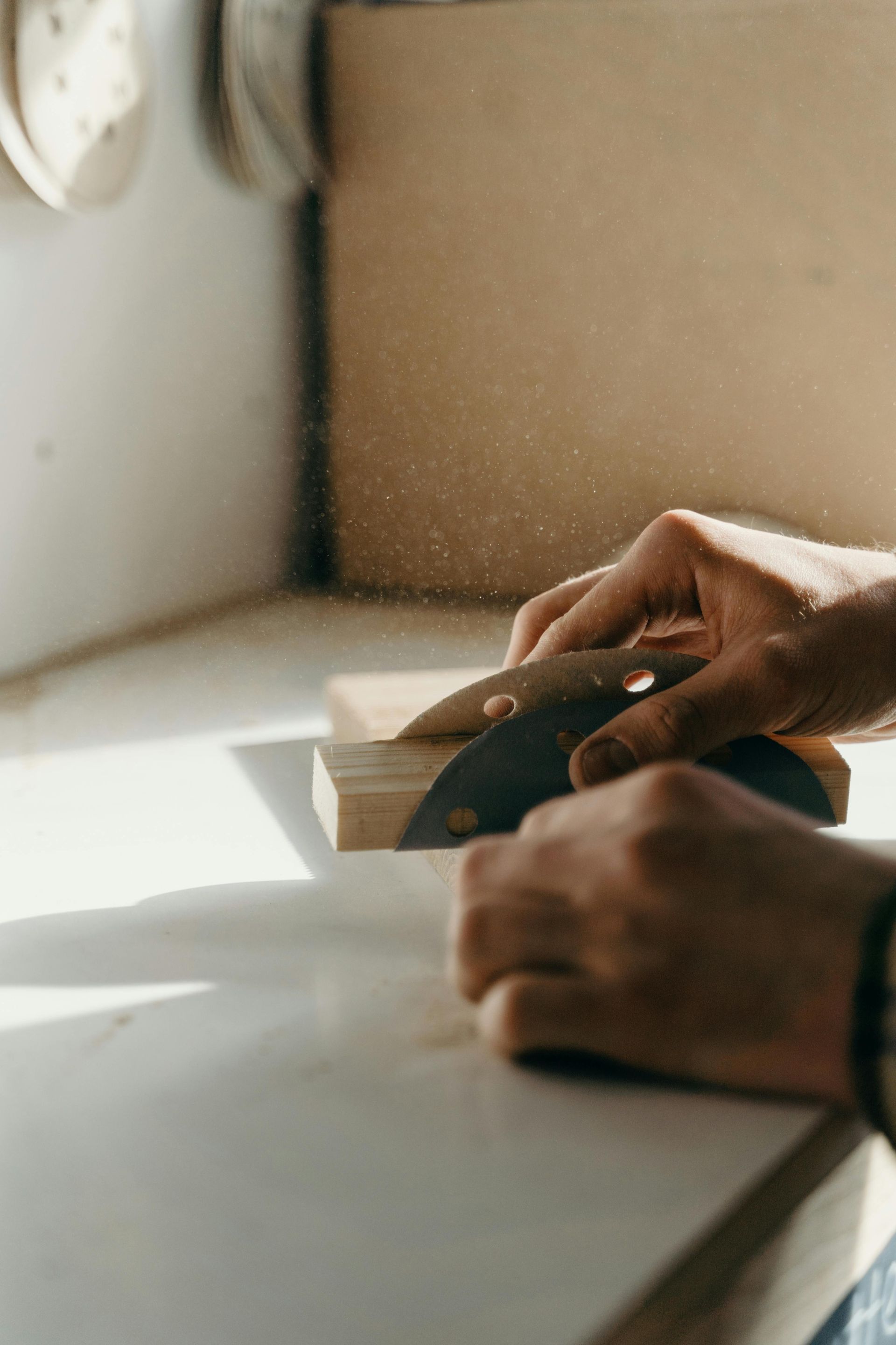 Professional painter sanding wood trim for a smooth custom finish by Green Valley Painters in Arizona.
