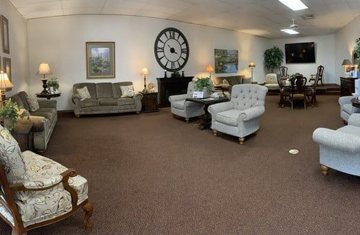 Several Photos of different caskets, gravestones, hearses, interior and exterior views of Kincannon Funeral Home in OK.