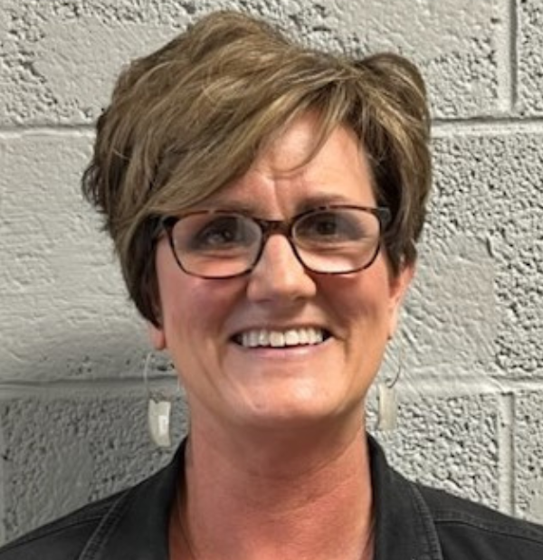 Kim Kerley, office manager for Sequatchie and Van Buren, wearing a professional black outfit