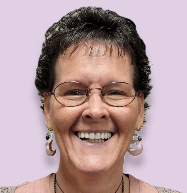 Kelly Gould, lead instructor, wearing an orange and black professional outfit