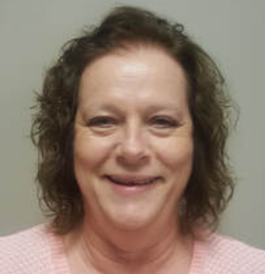 Brenda Smith, lead office manager, wearing a pink patterned professional shirt