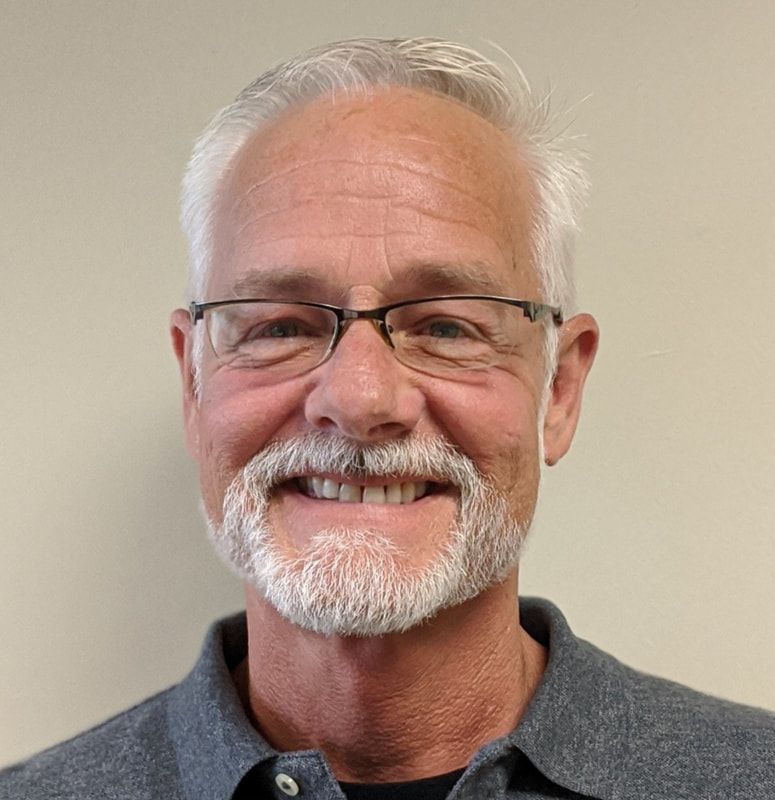 Grant Roddy, assistant program director, wearing a gray professional shirt