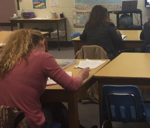 students in a classroom in adult education listening to an instructor