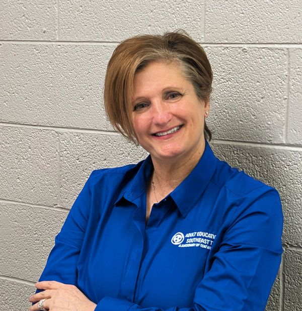Leslie Travis, program director, wearing a blue professional shirt with tcat logo