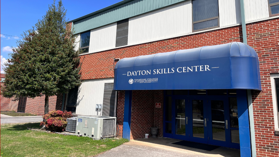 the front of the Dayton location building on a sunny day, the awning says Dayton Skills Center