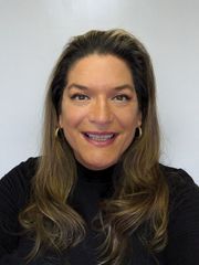 One of the team members, a female smiling in a professional black outfit