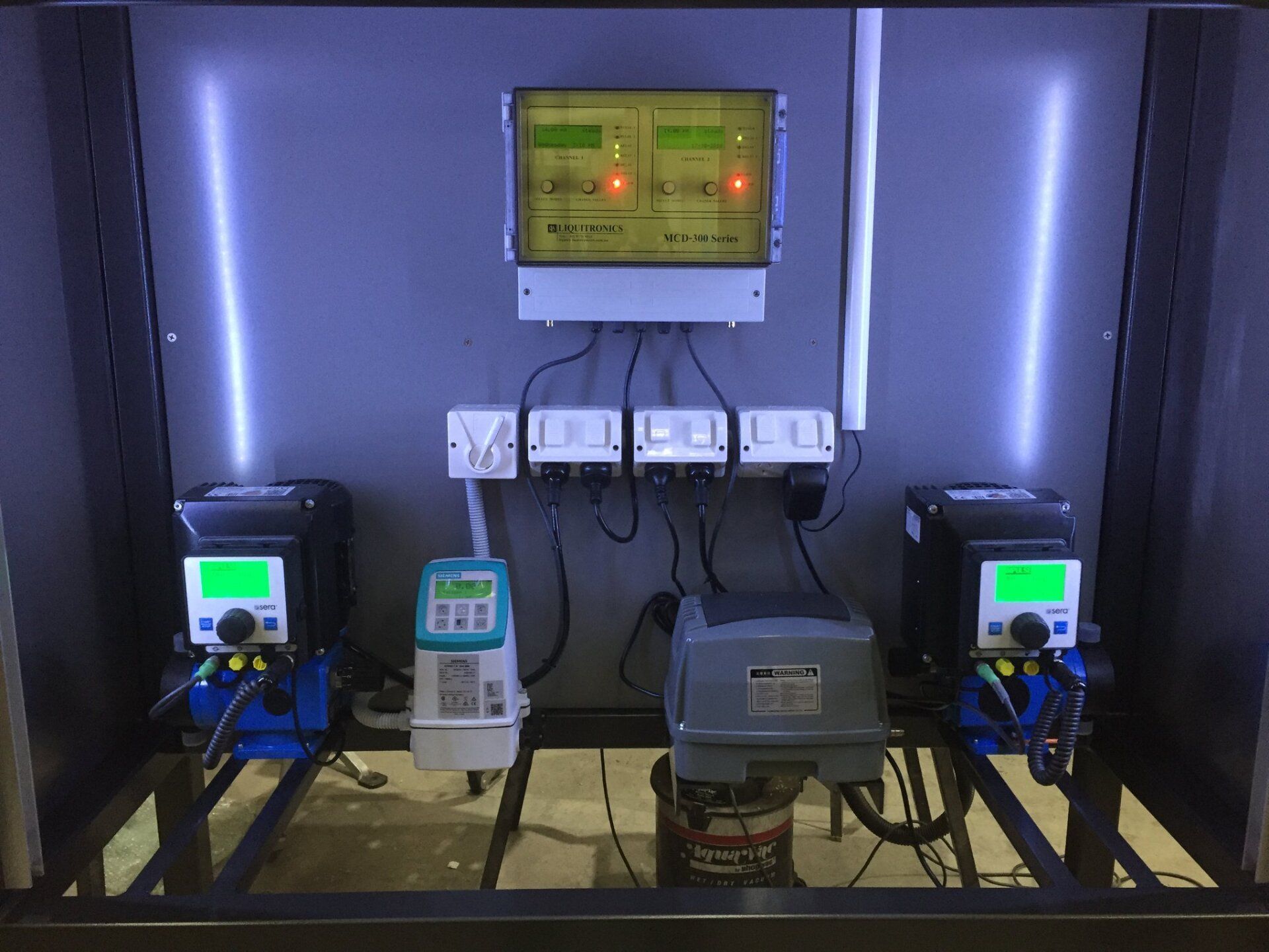 pH controller with dosing pumps and control panel.