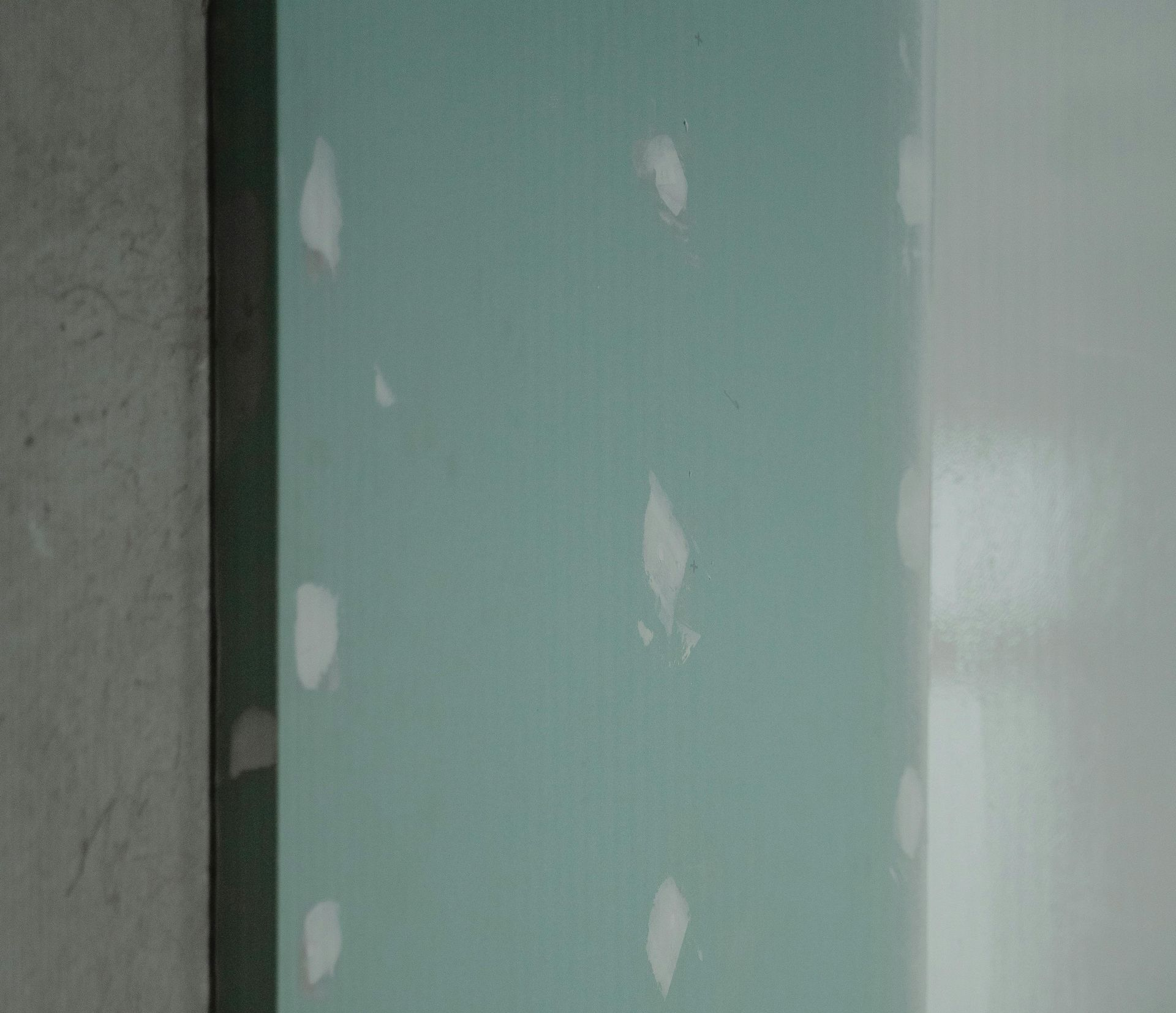 a kitchen under construction with blue tape on the floor .