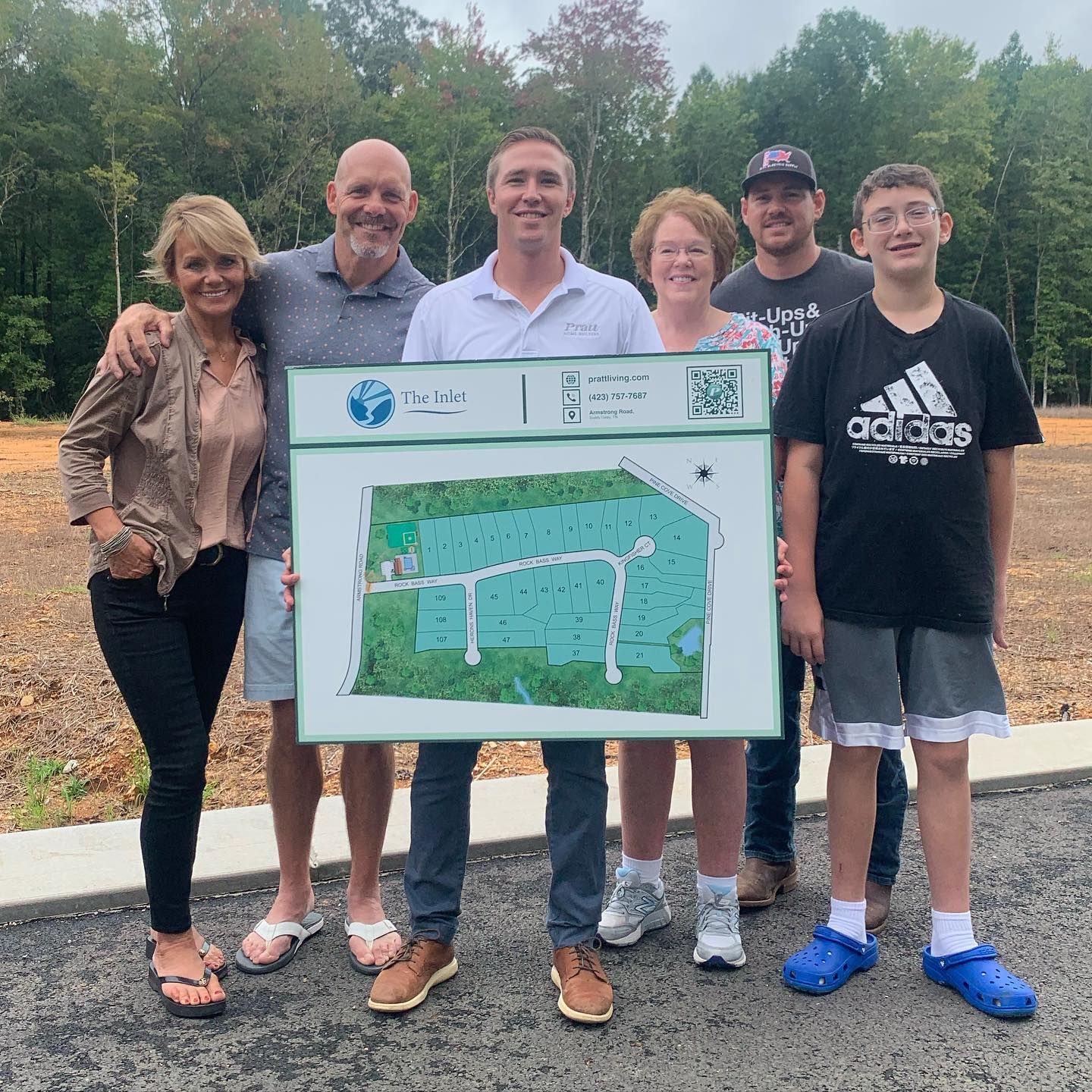 A group of people standing next to each other holding a map
