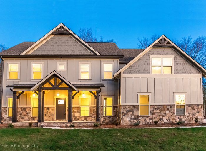 A large house with a lot of windows is lit up at night.