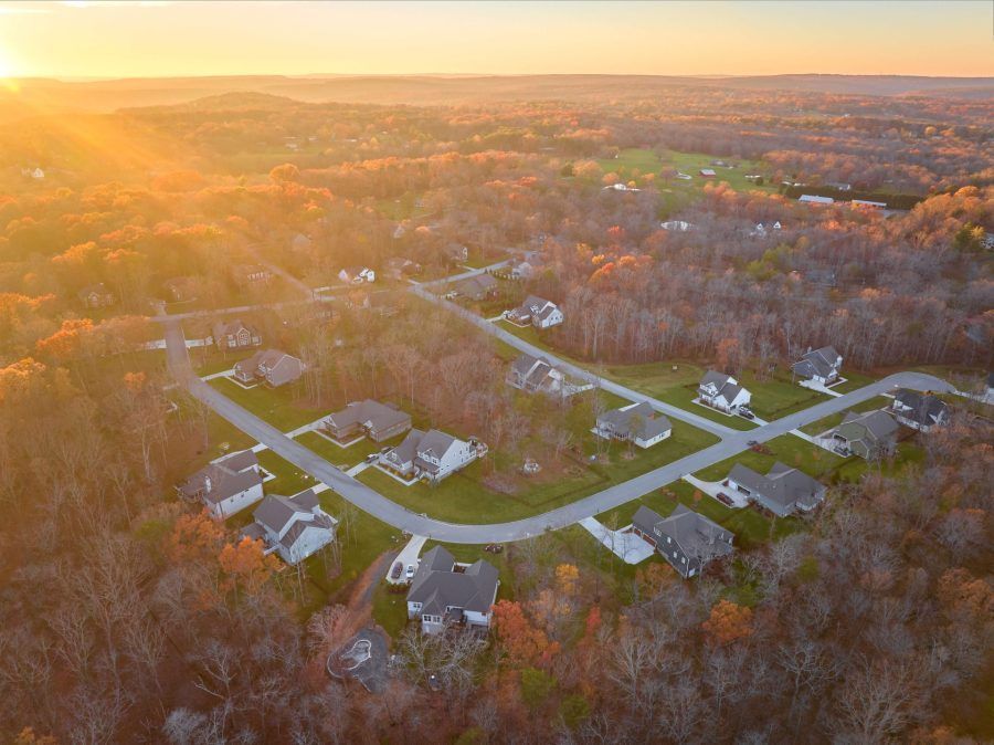An aerial view of a residential neighborhood at sunset.