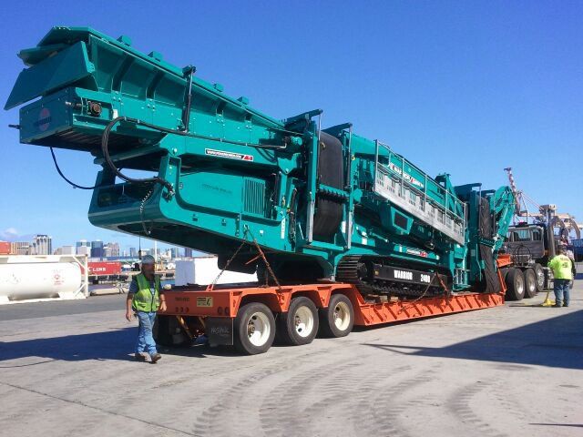 heavy duty crane being transported on a truck
