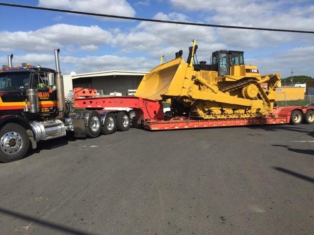 heavy duty machine being transported on a truck