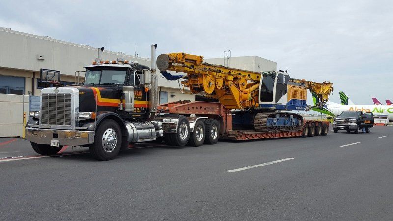 Heavy equipment being transported on a truck