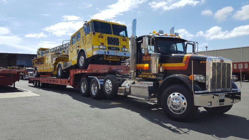 Heavy equipment being transported on a truck