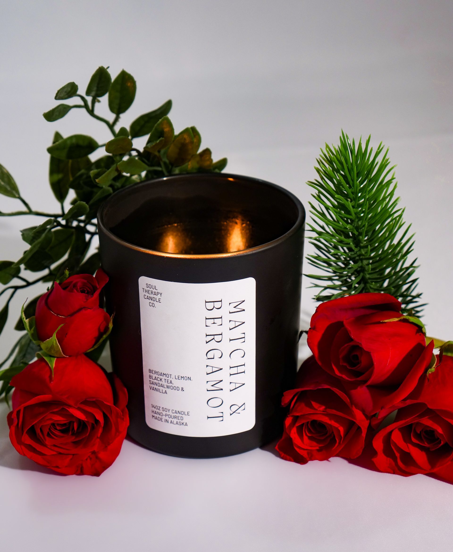 A black candle with a label that says ' swedish bergamot ' on it