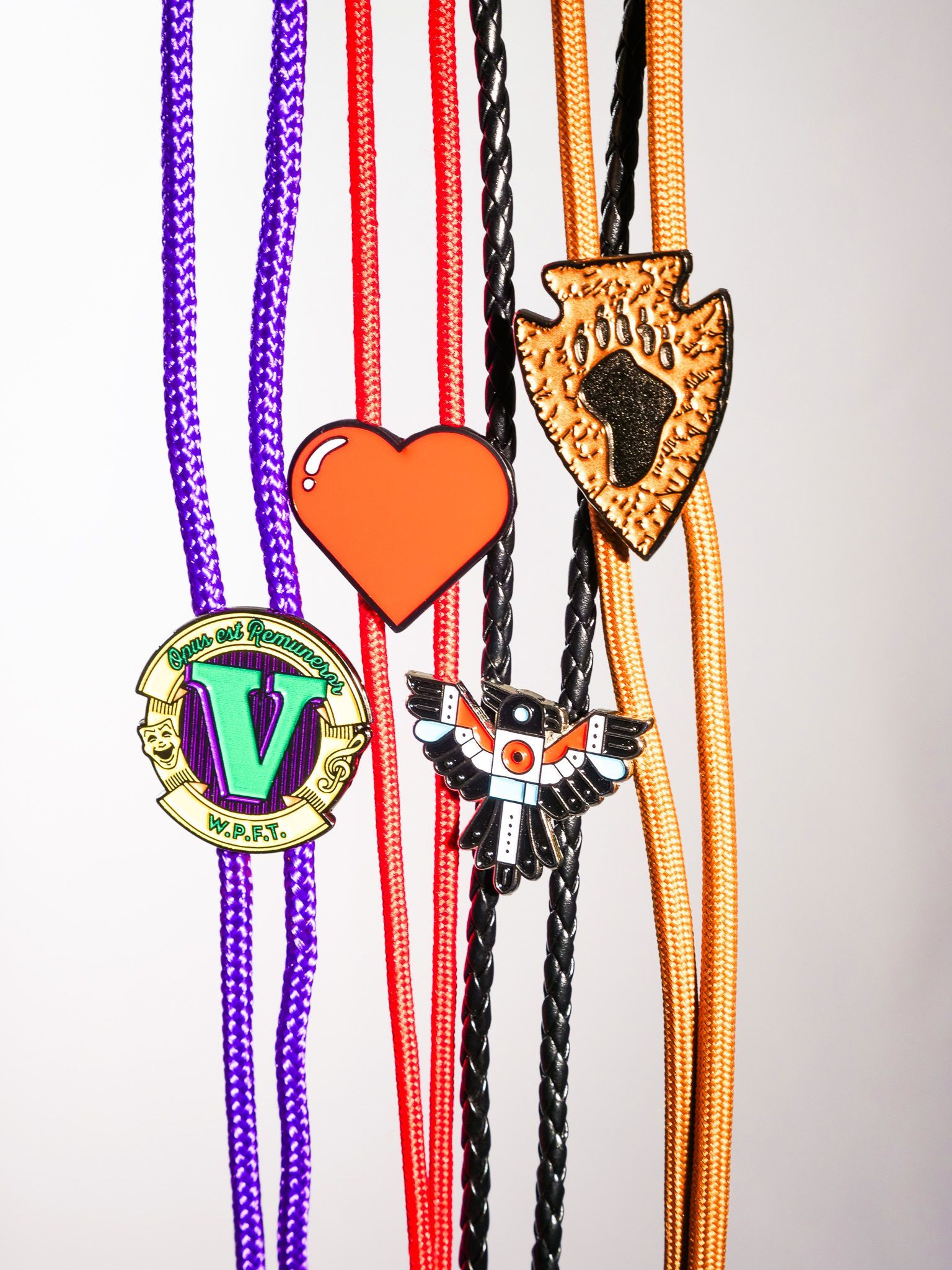 A row of bracelets with a heart and a letter v on them