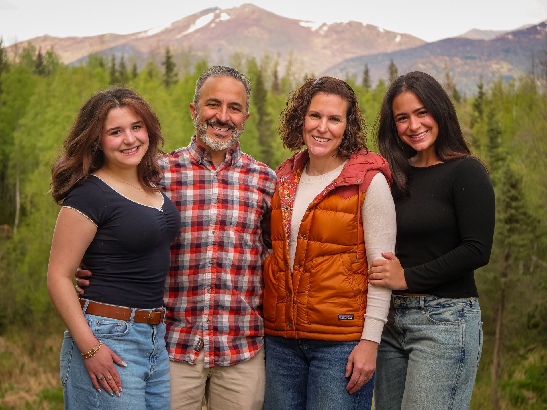 A man wearing a straw hat is walking down a dirt road.