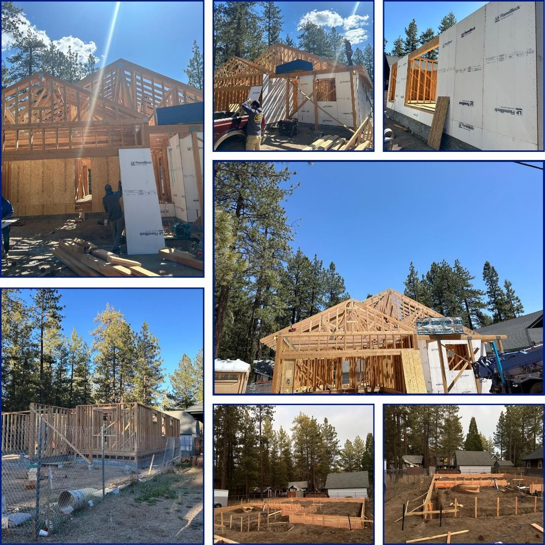 Construction of a new house, with wood framing and insulated panels, in a wooded area under a blue sky.