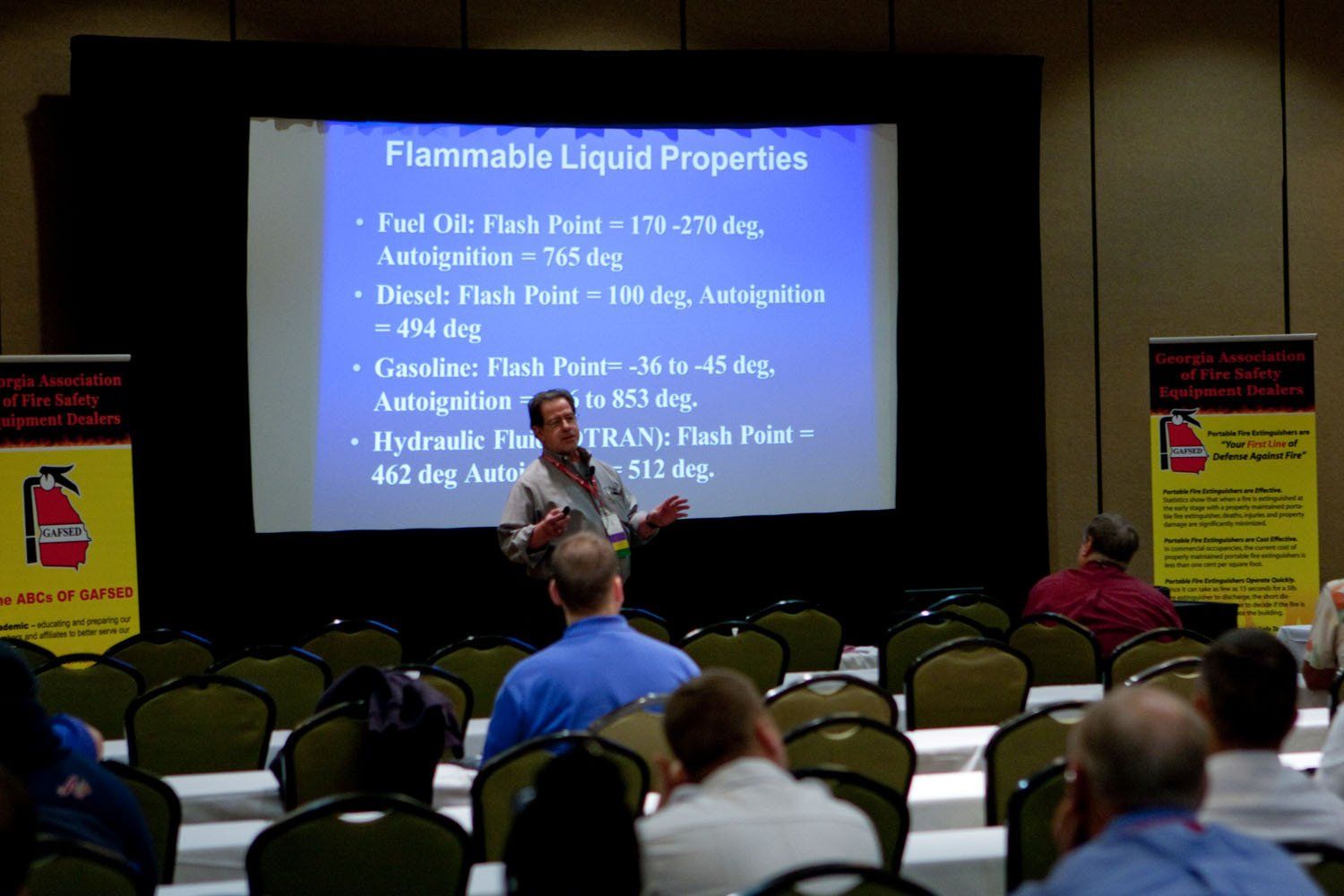 A man is giving a presentation about flammable liquid properties