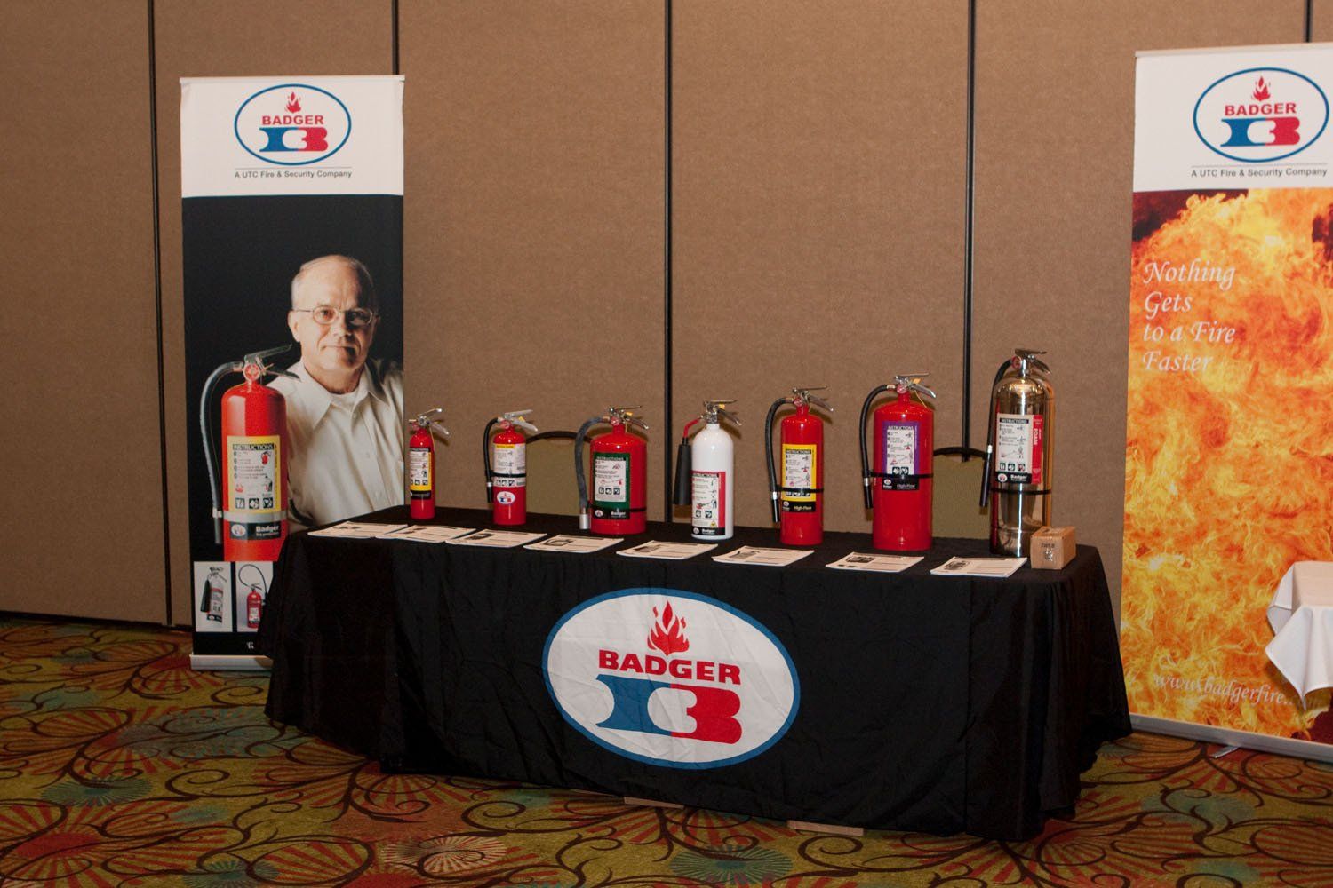 A table with badger fire extinguishers on it