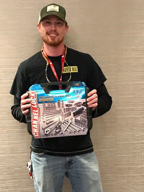 A man is holding a box of tools that says channel lock