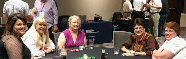 A group of people are sitting around a table in a room.