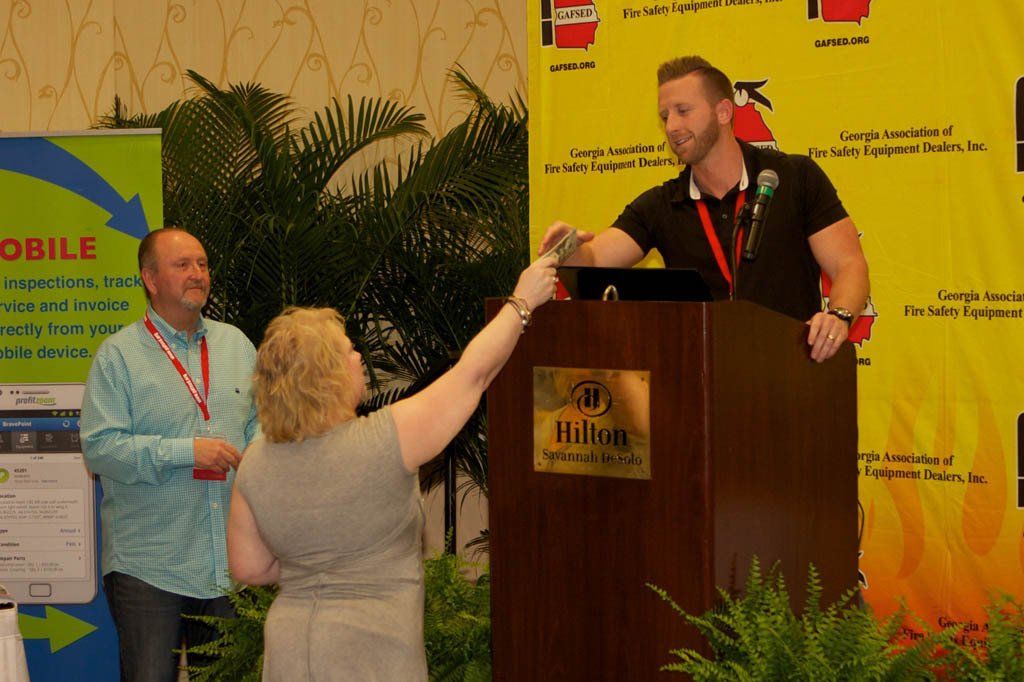 A man giving a speech at a hilton podium