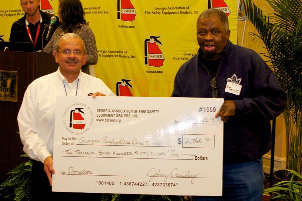 Two men are holding a large cheque that says ' # 1166 ' on it