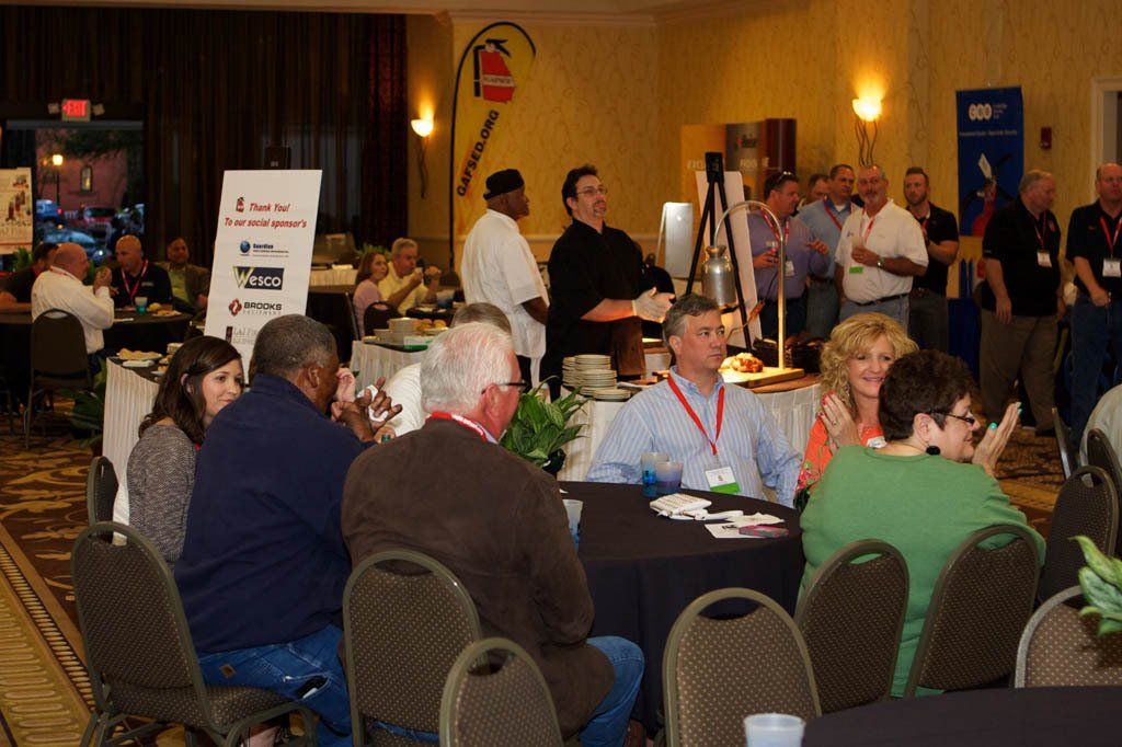 A group of people are sitting at tables in a room.