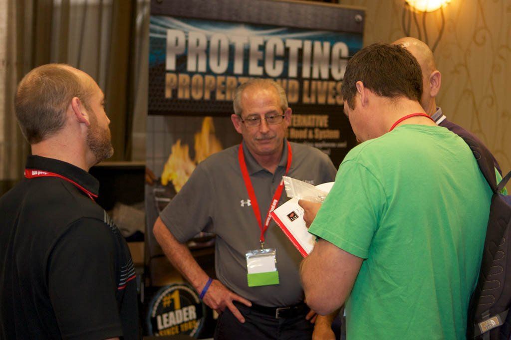 A group of men are standing in front of a sign that says protecting